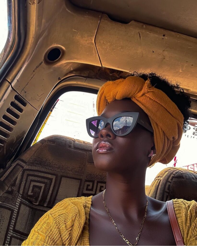 Angella Summer Namubiru in a taxi with sunglasses