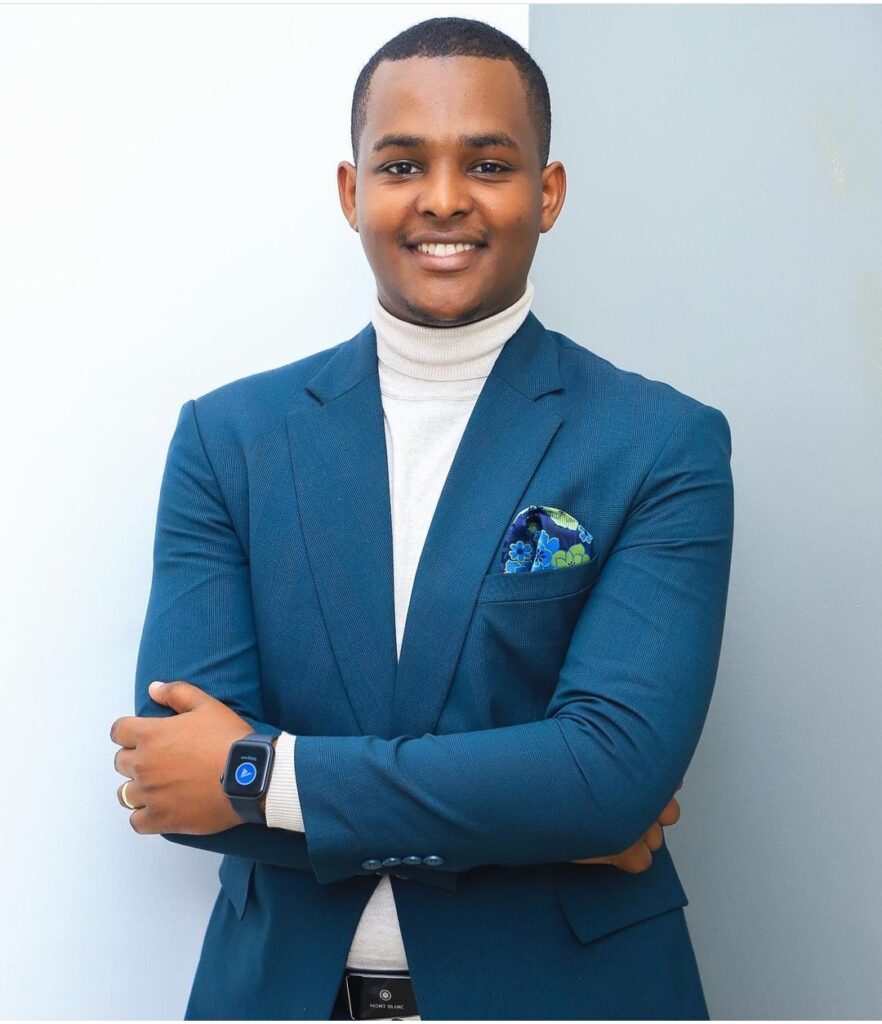 Canary Mugume | Reminiscing His Legacy At NBS TV 1 Canary Mugume smiling in greenish blue suit