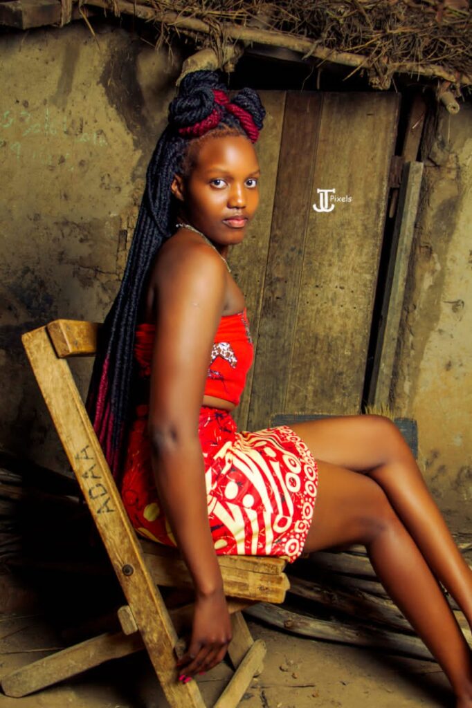 Stephanie Apila sits on village wooden chair