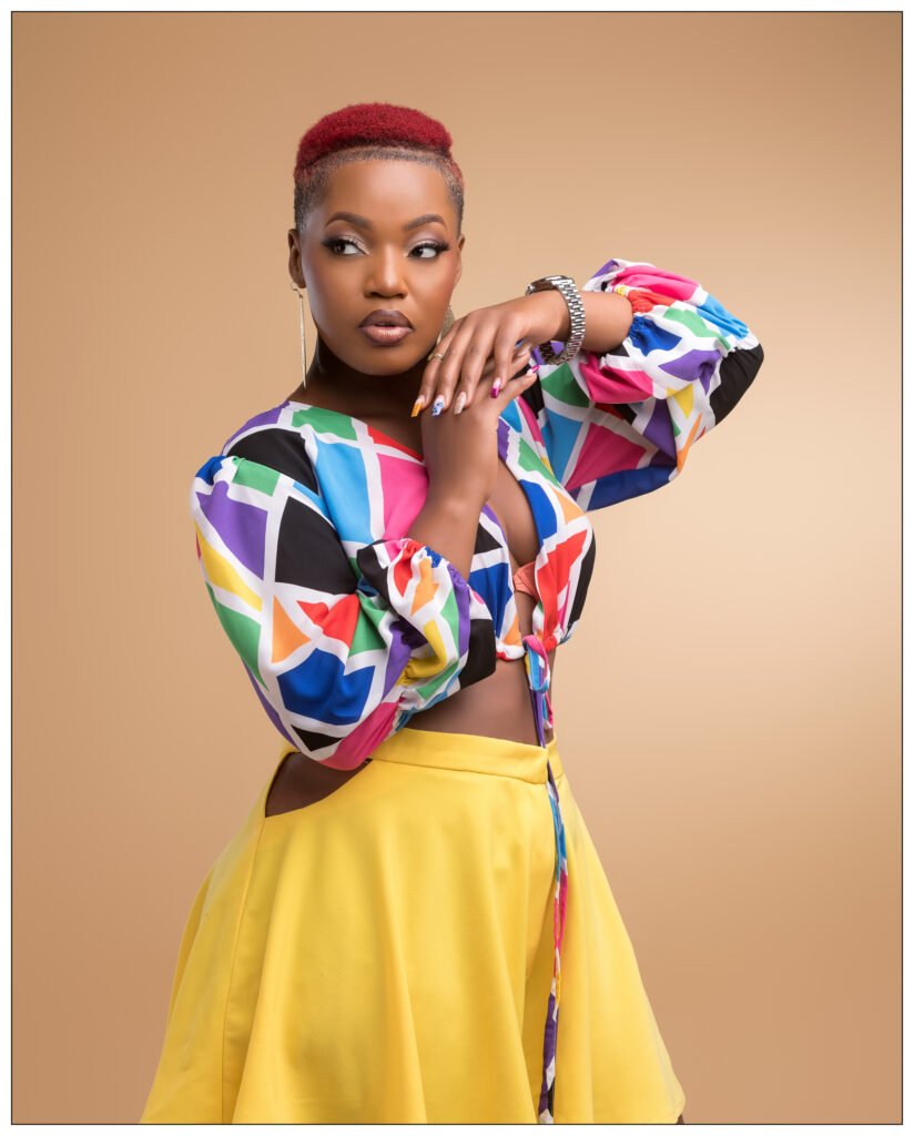stella nante posing in a beautiful multicolored blouse and yellow dress