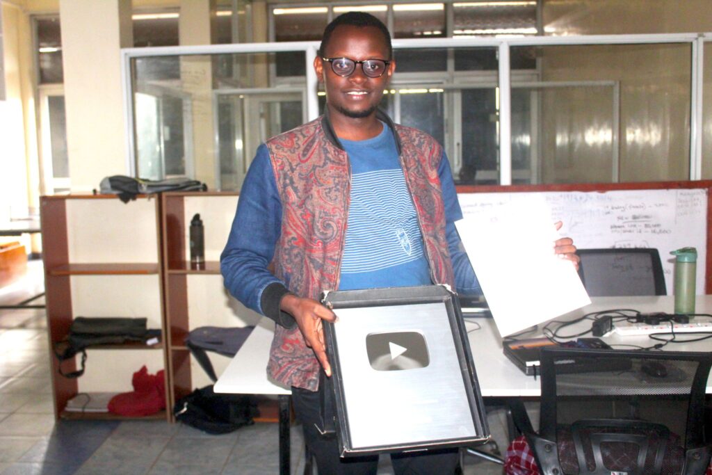 SAM NGARE HOLDS YOUTUBE SILVER PLAY BUTTON AFTER HITTING 100K SUBS