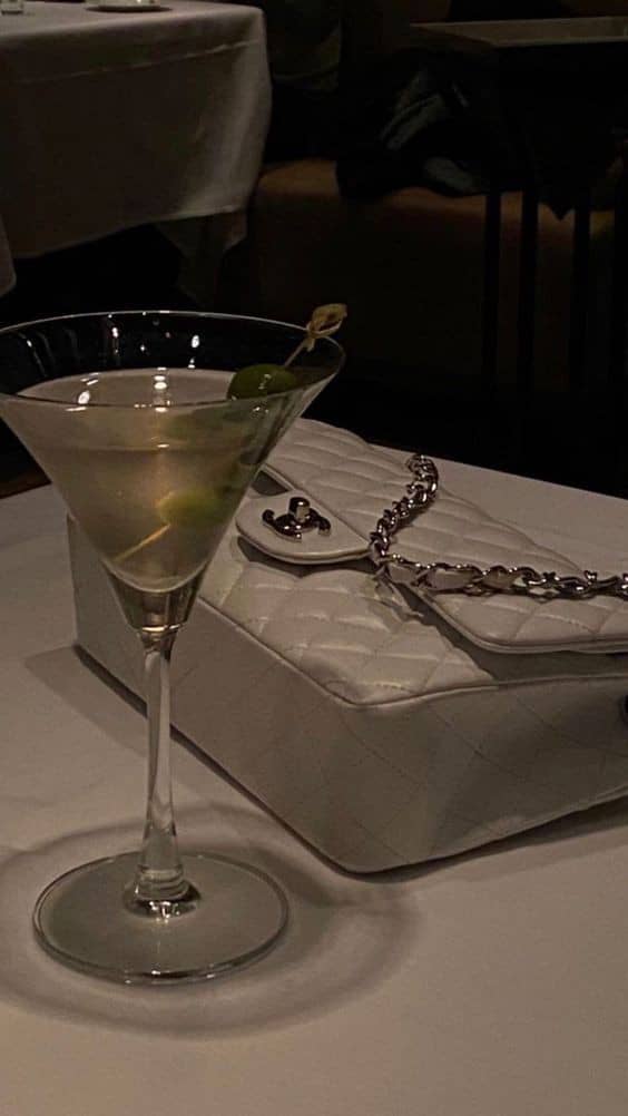 classy white bag and a glass of lemon juice