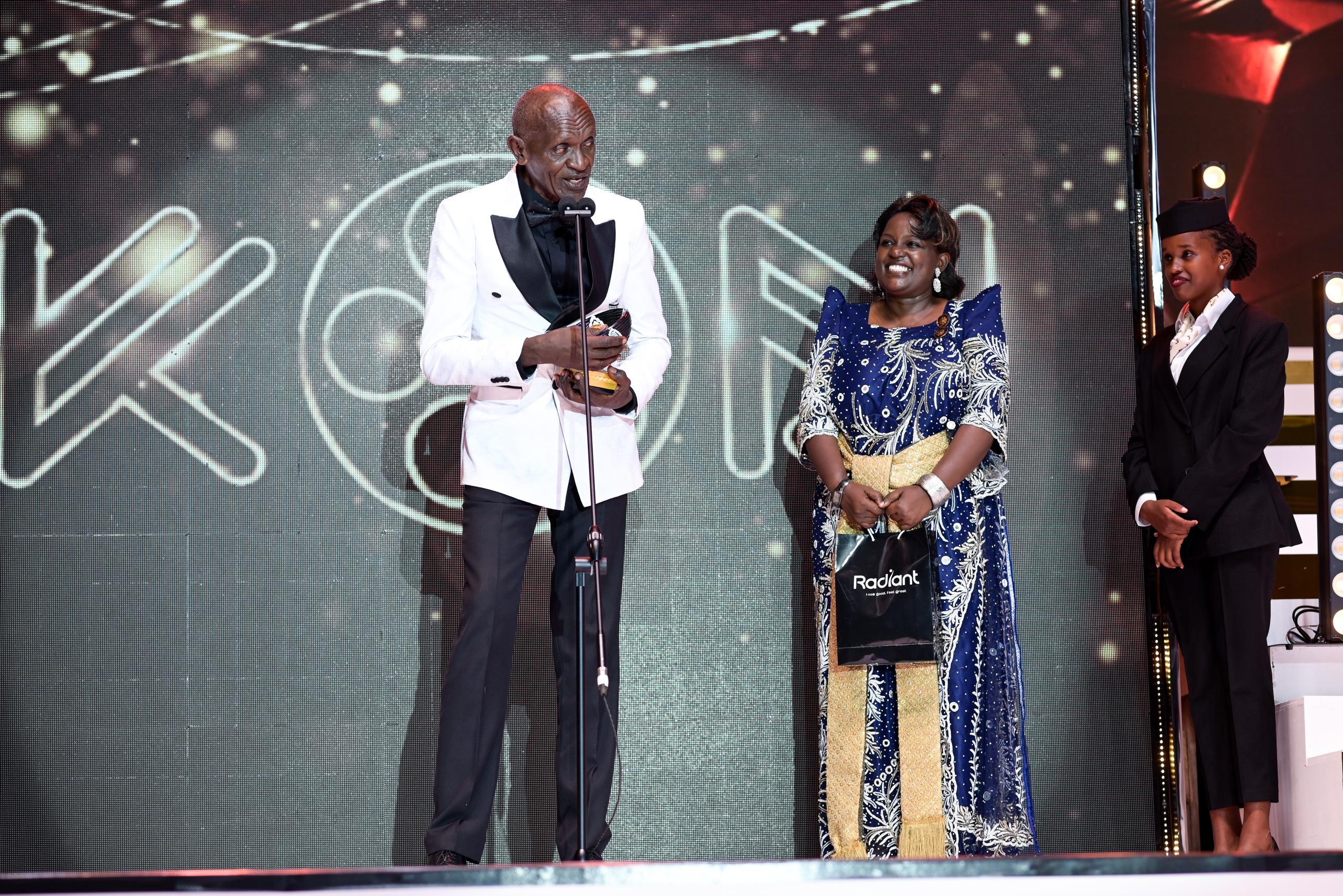 Michael Wawuyo Sr and Mariam Ndagire on stage