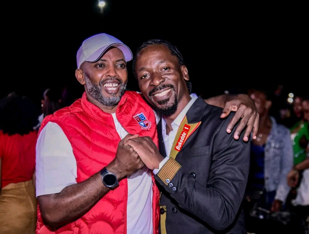 Prof. Muganga Lawrence poses for a photo with Isaac Ssemakadde at Neyanziza Concert